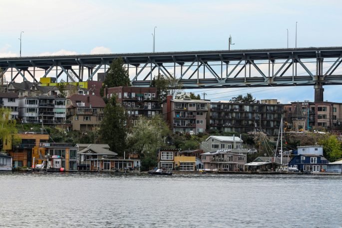a bridge over a body of water with houses on it